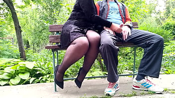 A mature woman receives an ejaculation in a public park